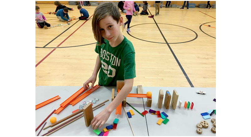 a child playing with blocks at a group activity